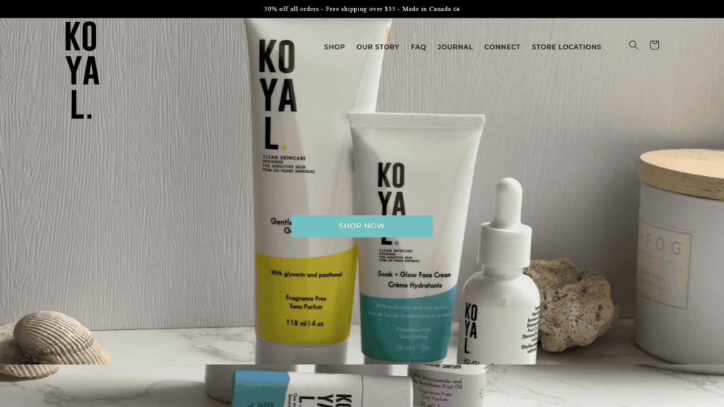 Koyal Beauty skincare products with a dropper and cream in minimalist setting.